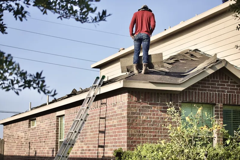 Professional roofer working on a residential roof in Gulf Coast